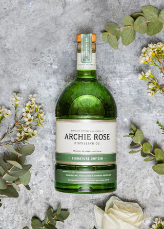 A bottle on the Archie Rose Signature Dry Gin surrounded by Aussie aromatics