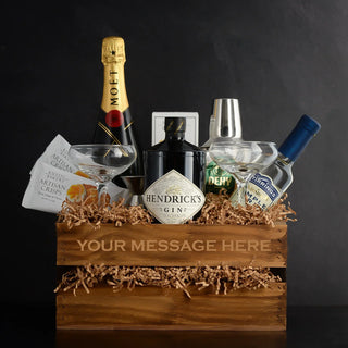 The image is showing a gift basket full of wine, spirits, glassware