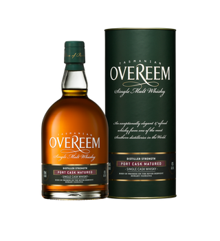 A bottle of Overeem Port Cask Matured – Distiller’s Strength Tasmanian Single Malt Whisky stands beside its green cylindrical case, featuring white and gold branding that showcases the product name and notes of sweet malt.