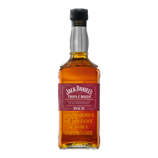 A bottle of Jack Daniel’s Triple Mash Tennessee Whiskey with a red label and gold embossed glass, 100 proof (50% alc/vol), hints of oak and dark cherry, is set against a plain white background.