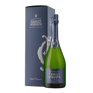 A bottle of Charles Heidsieck Brut Réserve NV (Gift Boxed) stands before its elegant dark blue box, both adorned with silver lettering—a fitting match for the champagne’s creamy texture and orchard fruit notes.