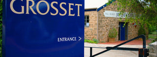 Grosset entrance sign with a building in the background