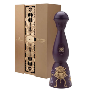 The Clase Azul Día de Los Muertos 2024 Música Limited Edition Tequila 1L comes in a tall, dark purple bottle with gold skeleton art and a tan box with gold designs, honoring Día de Muertos with notes of toasted oak and vanilla.