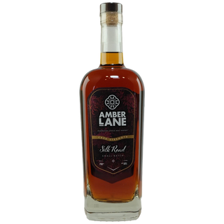 A bottle of Amber Lane Silk Road Australian Single Malt Whisky with a cork stopper, dark amber liquid, and a black and red label adorned with decorative patterns, offering aromas of dried fruits and brown sugar.