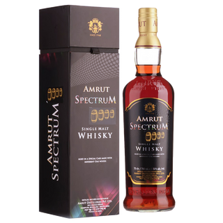 A bottle of Amrut Spectrum Indian Single Malt Whisky stands beside its black box adorned with gold and white text and a crest logo. The amber whisky delights with aromas of vanilla and dried mango.