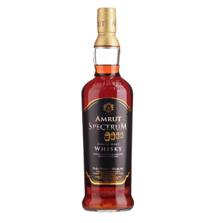 A bottle of Amrut Spectrum Indian Single Malt Whisky with a black and gold label, gold cap, and amber liquid—suggesting dried mango notes—displayed on a white background.