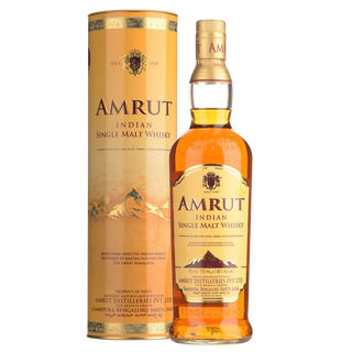 A bottle of Amrut Indian Single Malt Whisky stands beside its cylindrical packaging, both showcasing gold and brown tones with mountain graphics, black and red label details, and toffee notes on the palate.