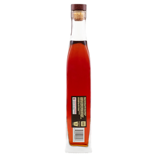 A tall, slender glass bottle of Angel’s Envy Kentucky Straight Bourbon Whiskey, filled with reddish-brown liquid hinting at vanilla and dark cherries, is sealed with a cork and wooden cap; the back shows a rectangular label with text and barcode.