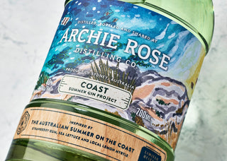 Bottle of Archie Rose gin with a scenic label on a light background