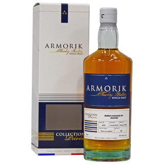 A bottle of Armorik Pineau des Charentes Single Cask French Whisky stands by its white box with blue and gold accents. The label notes batch details, while the box highlights its Collection Privee edition—ideal for fans of fruit toast flavors.
