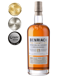 A bottle of Benriach The Twenty One Single Malt Scotch Whisky stands upright, with three award medals to the left. Notes of honey smoke and summer berries showcase its acclaimed character.