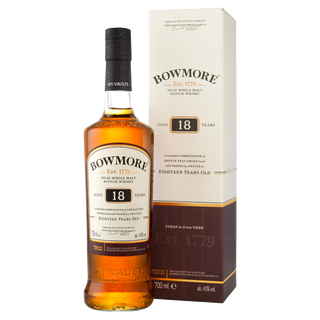 Bowmore 18 Year Old Single Malt Scotch Whisky is shown in front of its cream and brown box, with labels featuring gold and black text that suggest notes of dark chocolate and subtle peat smoke.