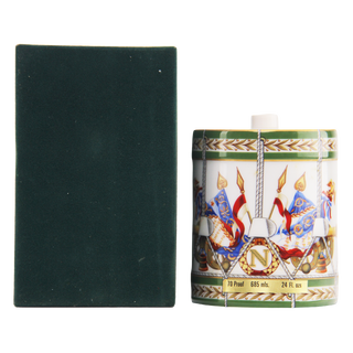 Decorative bottle with intricate design next to a dark green box on a white background