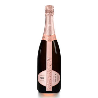 A bottle of Chandon Brut Rosé sparkling wine with fine bubbles, a pink foil-wrapped neck, and a pink label displaying the brand name vertically, stands upright on a white background.