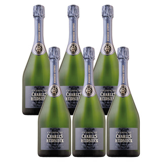 Six bottles of Charles Heidsieck Brut Réserve NV are arranged in two rows, featuring green glass, a silver label, and blue foil—elegantly presenting fine bubbles and delicate white peach notes.