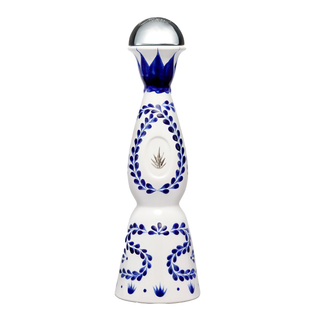 Clase Azul Reposado Tequila 500ml comes in a tall, white ceramic bottle with blue floral designs, a silver agave emblem, and a clear round stopper—capturing the essence of cooked agave and subtle vanilla notes.