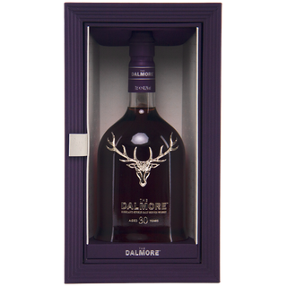 A bottle of The Dalmore 30 Year Old Single Malt Scotch Whisky comes in a purple box with a silver stag, offering rich Black Forest gateau and dark chocolate notes. Both the bottle and box feature The Dalmore branding.