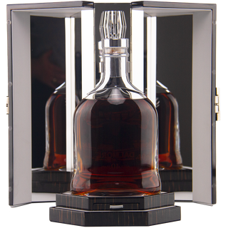 A bottle of The Dalmore 40 Year Old Single Malt Scotch Whisky with a silver cap stands before open mirrored doors, its image reflected from many angles. The black multi-tiered base hints at its rich Colombian coffee notes.