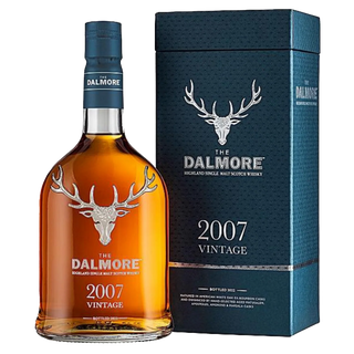 A bottle of The Dalmore 15 Year Old 2007 Vintage Single Malt Scotch Whisky stands beside its blue box, both displaying a silver stag logo and white text, with tasting notes of dark chocolate and orange marmalade.
