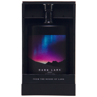 A bottle of Dark Lark 2024 Single Malt Whisky is displayed in a black box, its label showing a colorful aurora over mountain silhouettes and the text DARK LARK and FROM THE HOUSE OF LARK, evoking notes of blackcurrant crumble and mocha.