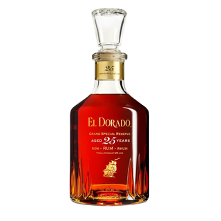 A bottle of El Dorado Grand Special Reserve aged 25 years rum on a clean white background. The bottle is made of clear glass with a stopper, showcasing the rich amber-brown liquid inside.