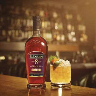 El Dorado 8 Year Old Rum bottle with a cocktail on a bar counter