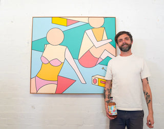 Man standing next to a colorful abstract painting on a white wall