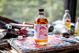 Bottle of whiskey with a label on a rustic wooden surface