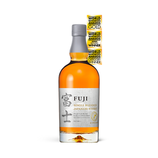 A bottle of Fuji Single Blended Japanese Whisky with a white label and World Whiskies Awards gold medals above it, set against a plain background—this whisky offers fruity notes and subtle hints of apricot.