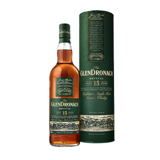 A bottle of Glendronach 15 Year Old Revival Single Malt Scotch Whisky stands beside its matching green cylindrical box, both adorned with gold and white accents on their labels, evoking sherry cask influence and notes of dark chocolate.