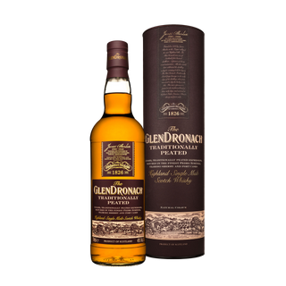 A bottle of Glendronach Traditionally Peated Single Malt Scotch Whisky is displayed next to its matching cylindrical box, both adorned with brown and gold labels that showcase rich peat smoke and the brand’s distinctive design.
