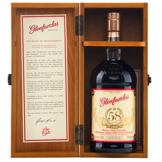 Glenfarclas 58 year old whisky bottle in a wooden case with a certificate inside.