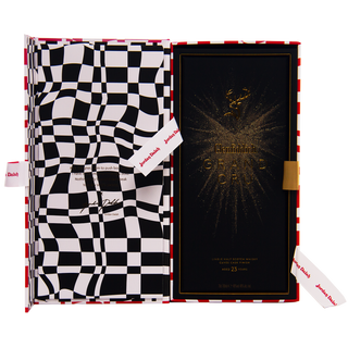 A luxury box with a black and white checkered pattern holds the Glenfiddich Grand Cru 23 Year Old x Jordan Dalah, featuring gold-accented packaging. Notes of sandalwood and peach complement red accents and signature-style text inside.