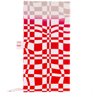 The Glenfiddich Grand Cru 23 Year Old x Jordan Dalah Box Set features a red and white checkered, wavy-patterned box with a faded gradient top and a white pen holder labeled “Dalah,” evoking the warmth of brioche and banana.