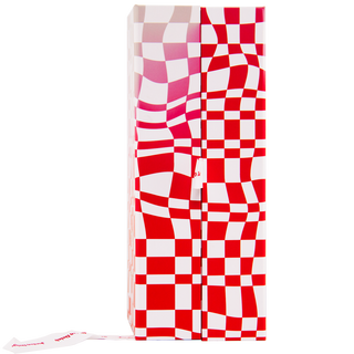 The Glenfiddich Grand Cru 23 Year Old x Jordan Dalah Box Set features a rectangular box with a red and white distorted checkerboard pattern, reminiscent of flaky pastry. A tissue is partially pulled out from the lower left corner, set against a plain white background.