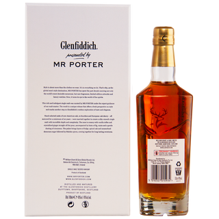 A bottle of Glenfiddich Mr. Porter 20 Year Old Single Malt Scotch Whisky with a gold cap stands next to a white "Glenfiddich presented by MR PORTER" box, featuring the stag logo and notes of fruity effervescence on its label.