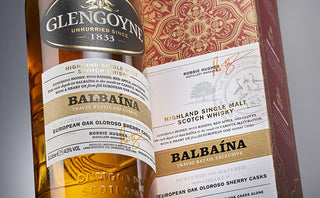 Close-up of a Glengoyne Balbaina Single Malt Scotch Whisky bottle and packaging with white and gold labels, featuring "Balbaína," sherry cask details, signatures, and notes of rich sherry and spiced raisins.