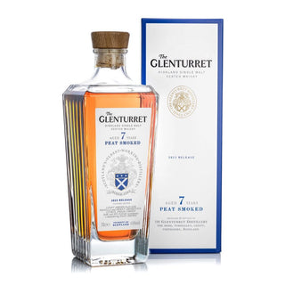 A bottle of Glenturret 7 Year Old Peat Smoked Single Malt Scotch Whisky with a wooden cap sits beside its blue and white 2022 release box, both highlighting the whisky’s rich peat smoke character.