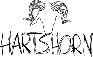 Black and white graphic design featuring a stylized ram skull with curved horns above the word 'HARTSHORN' in a rough, hand-drawn brushstroke font.