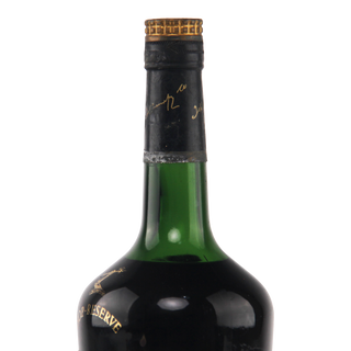 Green wine bottle with gold cap on a white background