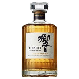 A bottle of Hibiki Japanese Harmony Blended Japanese Whisky, in a faceted clear glass bottle with a white label, filled with amber whisky and known for its honey and floral notes.
