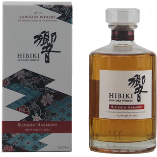 A bottle of Suntory Whisky Hibiki Blossom Harmony whisky next to its retail box. The bottle contains amber-colored whisky and has a white label with black calligraphy and a red accent band.