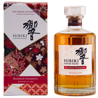 A bottle of Hibiki Suntory Whisky 'Blossom Harmony' next to its matching product box. The bottle is filled with amber-colored whisky and features a white label with black and red text.