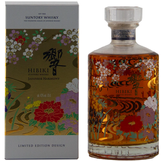 Suntory Whisky Hibiki Japanese Harmony Limited Edition whisky bottle next to its illustrated packaging box. The clear glass bottle contains amber-colored whisky and features a colorful floral and wave pattern.