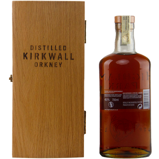Whiskey bottle with wooden box labeled 'Distilled Kirkwall Orkney' on a white background