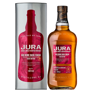 A bottle of Jura Red Wine Cask Finish Single Malt Scotch Whisky stands beside its matching cylindrical box, both adorned with red and gold labels that highlight the whisky's caramel and raisin notes, along with detailed product branding.