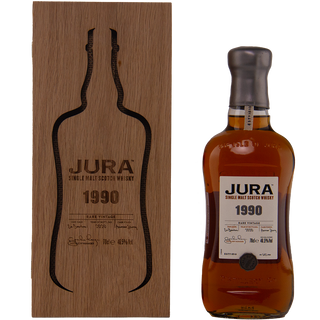 Jura 1990 whisky bottle and wooden box on a white background