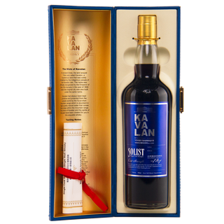 A bottle of Kavalan Solist Vinho Barrique Cask W120120118A Single Malt Whisky in a blue box with gold interior, printed details, and a scroll tied with a red ribbon. Enjoy every sip’s tropical fruit notes and wine-cask sweetness.