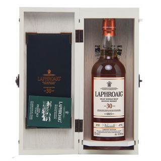 Laphroaig 30-year-old whisky bottle in a wooden box with a book inside.