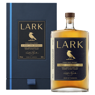 A bottle of Lark Cask Strength Tasmanian Single Malt Whisky with a navy and gold label stands before its matching box. The amber whisky offers notes of spiced pastry and golden syrup, reflecting the elegance of its packaging.